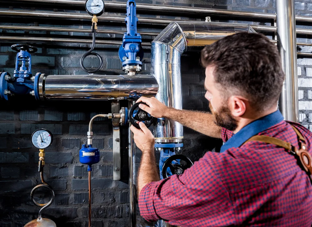 Technician inspecting a home hot water system